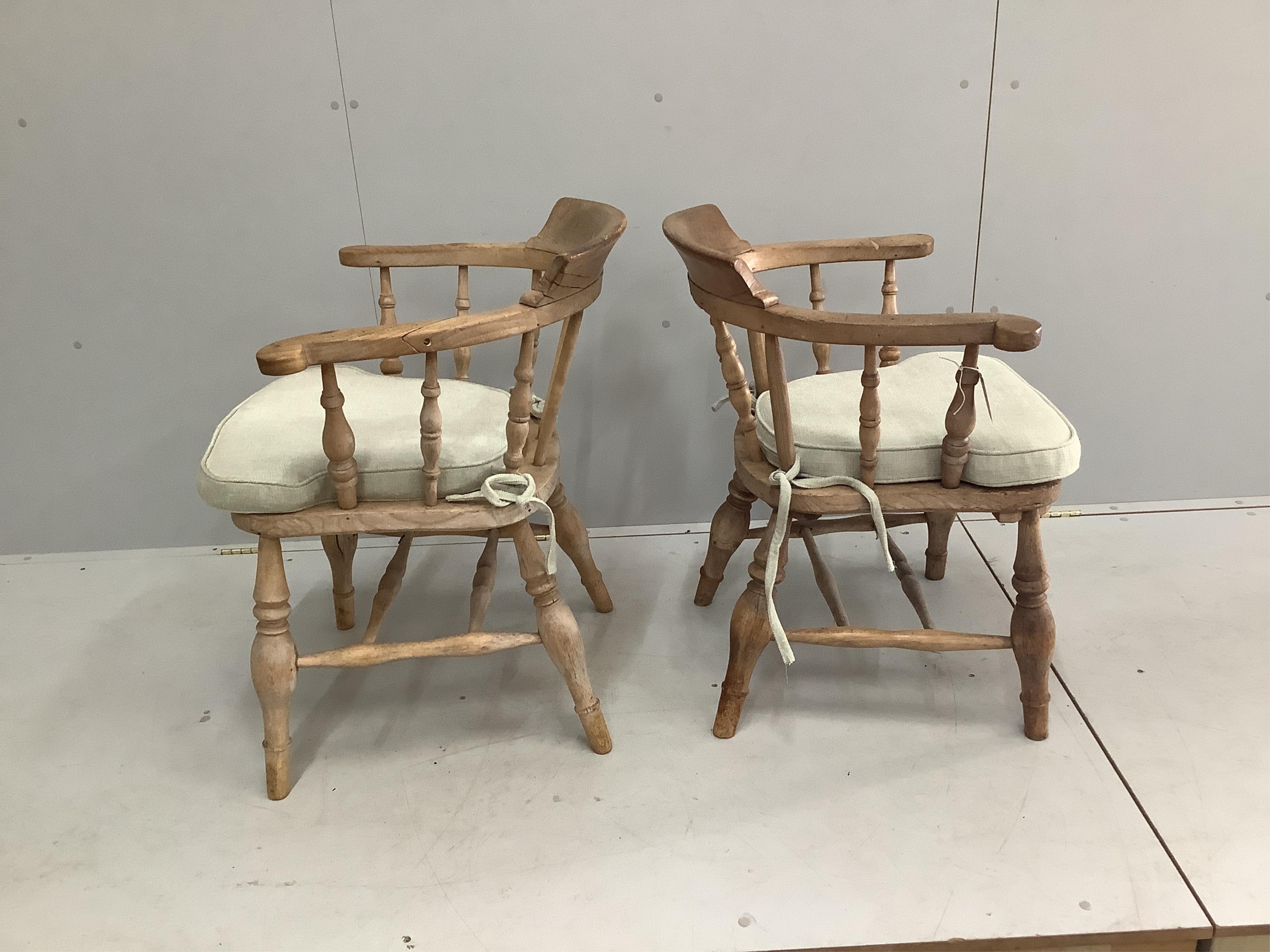 Two Victorian bleached elm and beech smoker’s bow chairs, larger width 64cm, depth 48cm, height 80cm. Condition - good